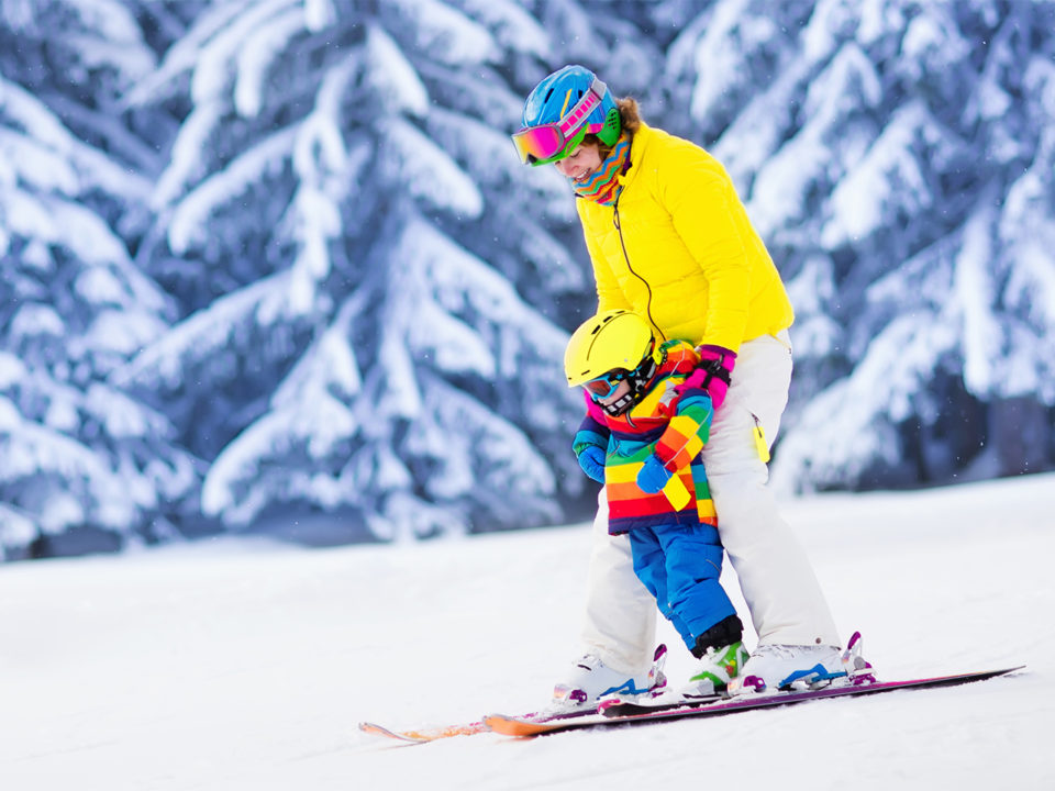 Mother and child skiing
