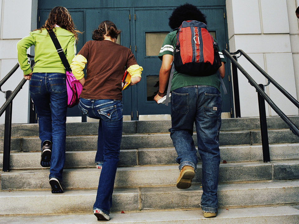 Kids running up school steps