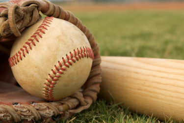 Baseball in a Glove near Bat