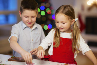 Brother and sister making sugar cookies