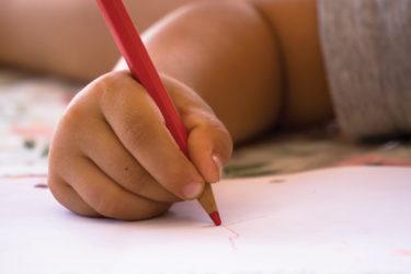 Kids writing on paper with pencil