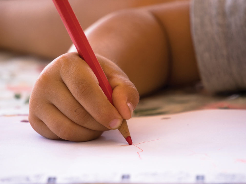 Kids writing on paper with pencil