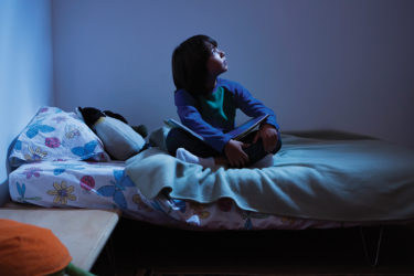 Boy in bed, afraid of the dark