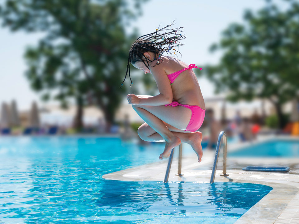 Girl jumping into swiming pool
