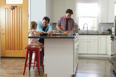Dads talking with daughter in kitchen