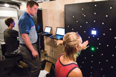 Student athletes testing in NeuraPerformance Brain Center's mobile center