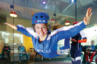 Woman indoor skydiving at iFly