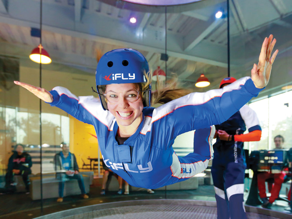 Woman indoor skydiving at iFly