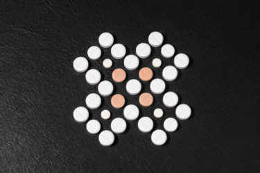 Series of pills aligned to form an X