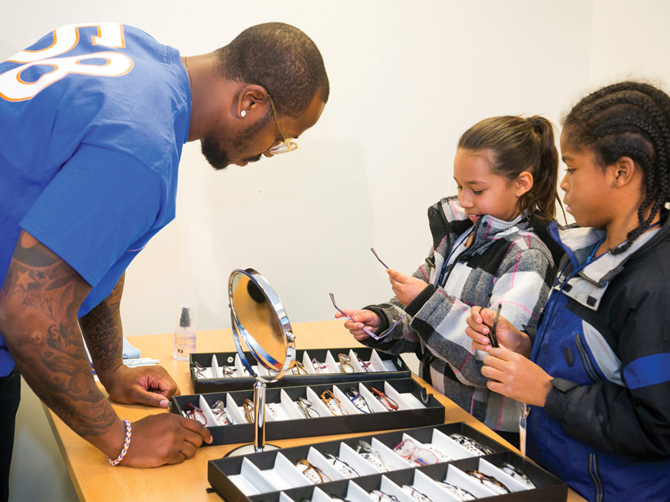 Children looking at eyeglasses through Von's Vision