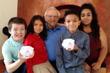 Ron Montoya and family with piggy banks