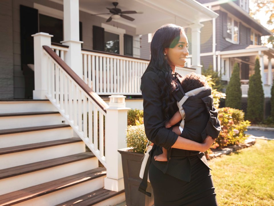 mom walking outside with her baby strapped to her chest