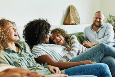 family laughing on couch
