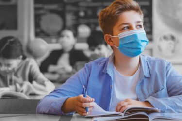 Boy at school wearing mask
