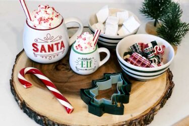 Hot cocoa setup on a log slice
