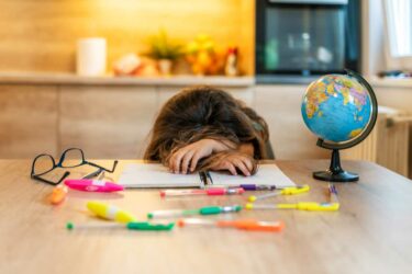 Girl with her head on table
