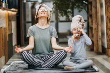 Mother and daughter in yoga pose