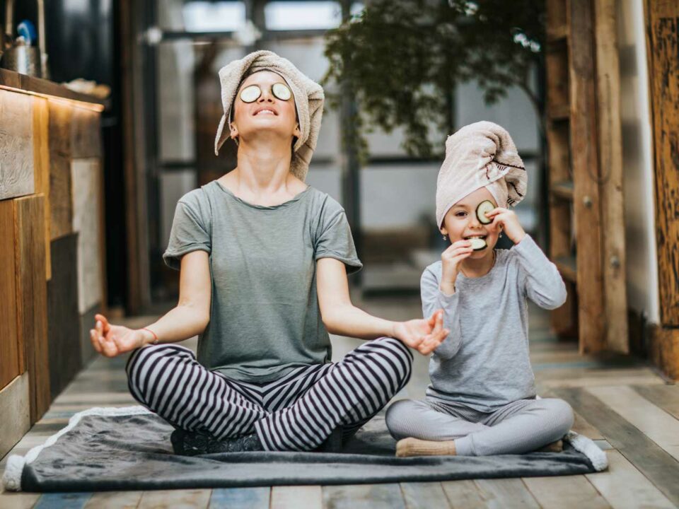 Mother and daughter in yoga pose