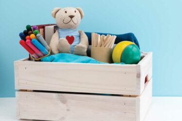 Toys and art supplies in crate