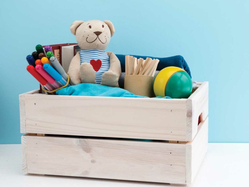 Toys and art supplies in crate