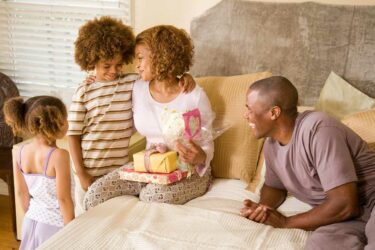 Family giving mother a gift