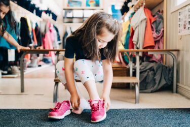 Child putting shoes on