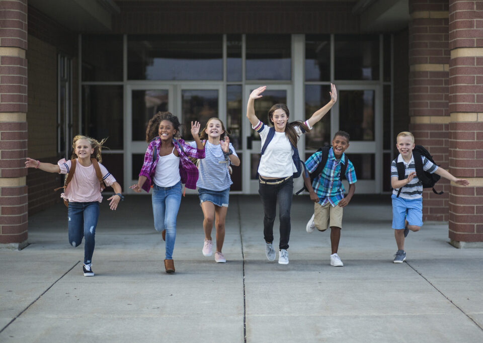 Children running out of school building