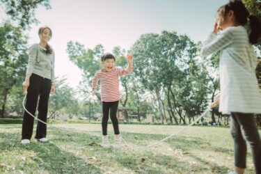 Family jump roping outdoors