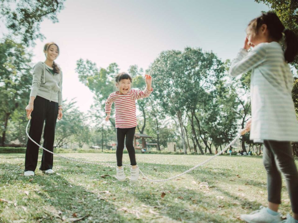 Family jump roping outdoors