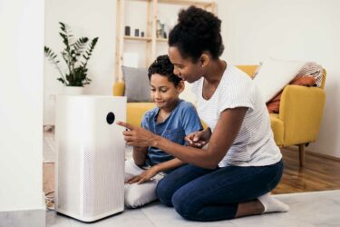 Mother and child with air purifier