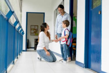 Parent and teacher talking at school