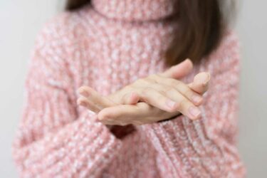 Woman putting lotion on hands