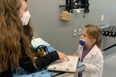 Child and woman examining charts