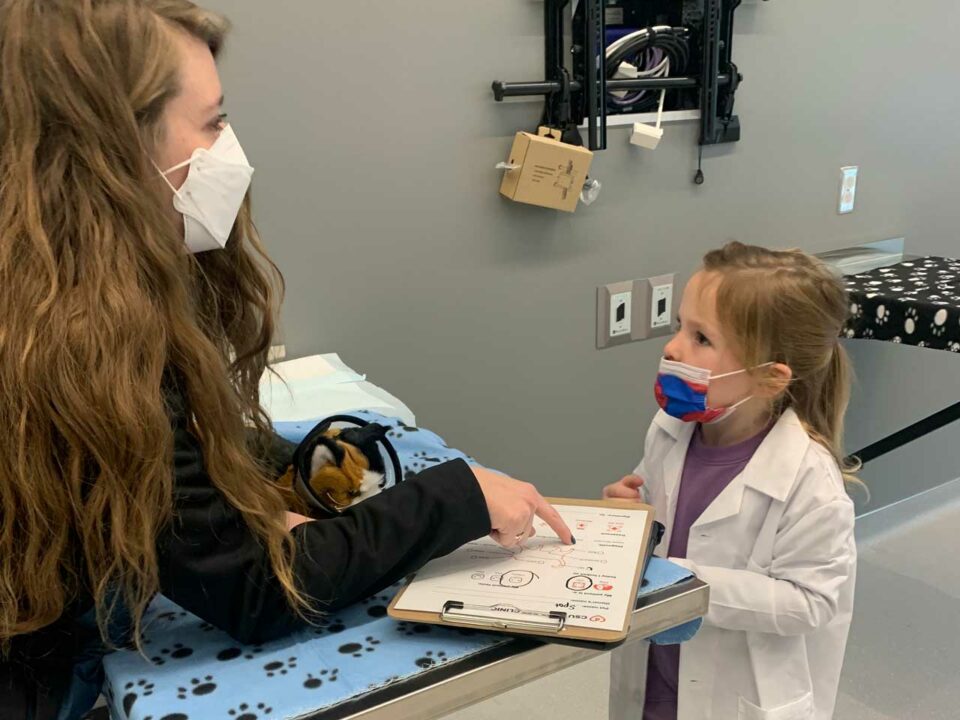 Child and woman examining charts