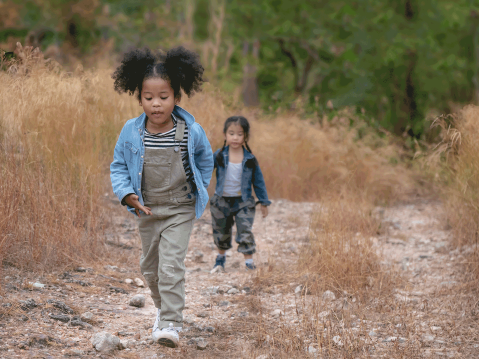 Two children on a hike in the woods
