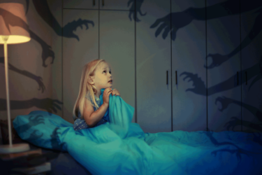 Little girl in bed having nightmares