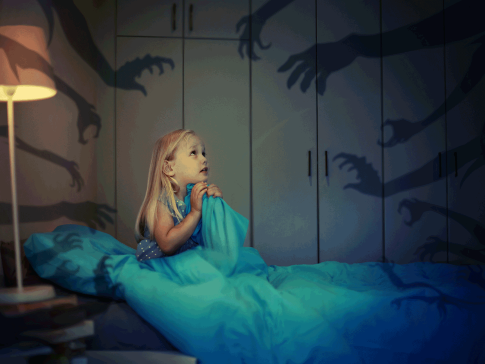 Little girl in bed having nightmares