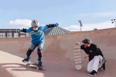 child during skateboarding lesson