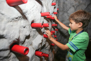 Child playing with sensory wall