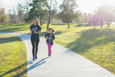 Woman and child running in the park