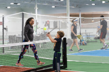 Boy and woman on Pickleball court