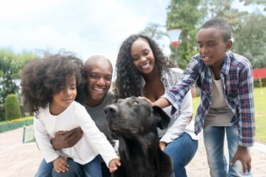 family with dog outside