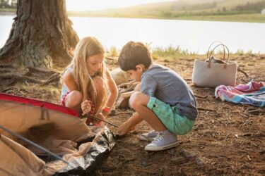 Children setting up a tent