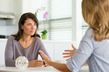 Women talking at kitchen table