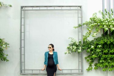 Pregnant woman by wall