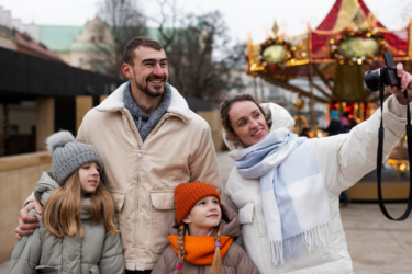 family taking a selfie together at a carnival