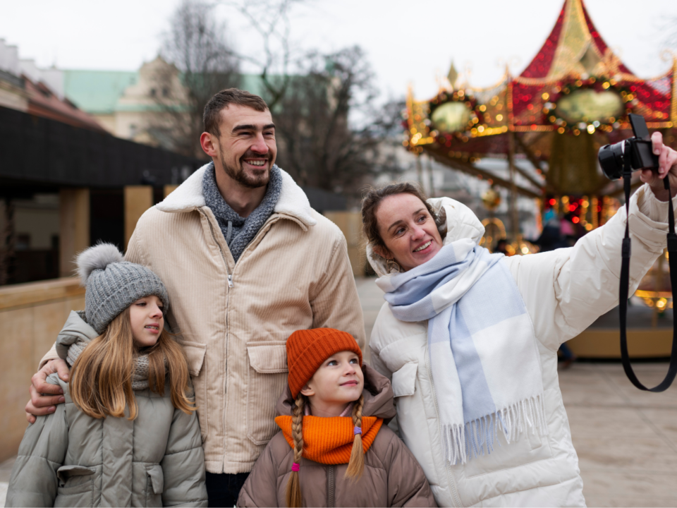 family taking a selfie together at a carnival