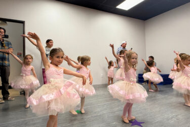 children dancing in a dance class with ballerina tutus