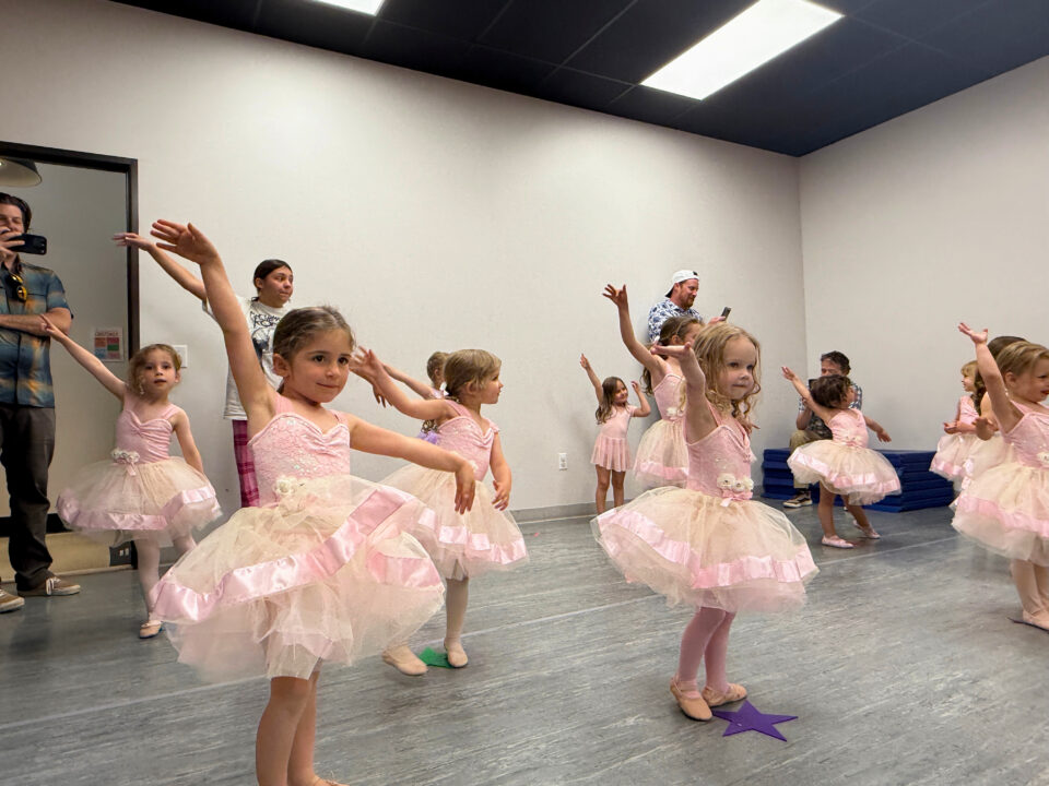 children dancing in a dance class with ballerina tutus